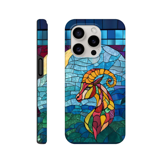 iPhone case featuring a vibrant stained-glass mosaic art illustration of a Capricorn sea-goat. The design shows the goat's head and upper body in segmented colors of red, orange, yellow, and green, against a background of blues and greens resembling water and sky, with dark separating lines.