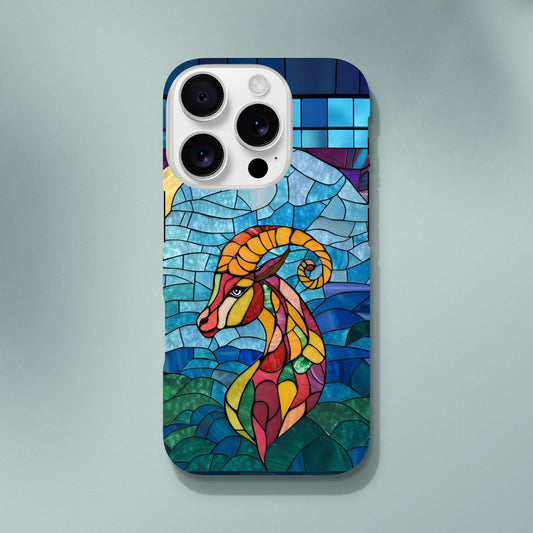 iPhone case featuring a vibrant stained-glass mosaic art illustration of a Capricorn sea-goat. The design shows the goat's head and upper body in segmented colors of red, orange, yellow, and green, against a background of blues and greens resembling water and sky, with dark separating lines.