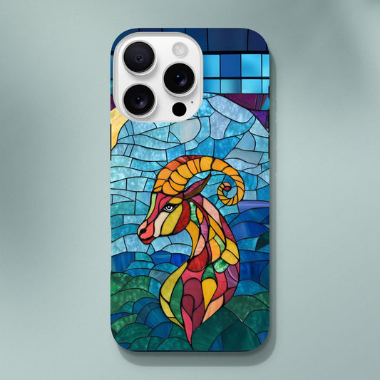 iPhone case featuring a vibrant stained-glass mosaic art illustration of a Capricorn sea-goat. The design shows the goat's head and upper body in segmented colors of red, orange, yellow, and green, against a background of blues and greens resembling water and sky, with dark separating lines.